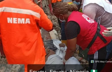 Rescue workers search debris after building collapse in Enugu