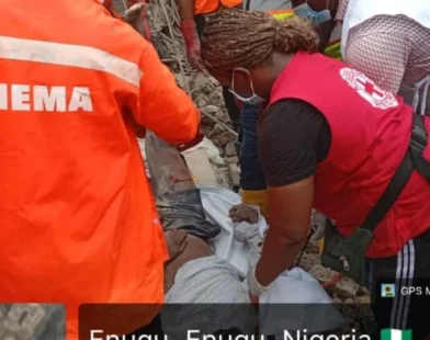 Rescue workers search debris after building collapse in Enugu