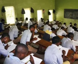 Students writing an examination in a hall as FG proposes a harmonised 2027 examination timetable.